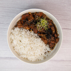 Caramel pork recipe with rice and black sesame seeds. High quality photo