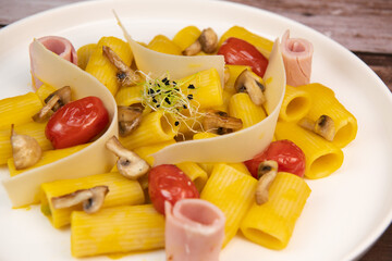 Recipe for Rigatoni Pasta with Chiatsu Squash Cream, Ham, Tomato, Mushrooms and Parmesan. High quality photo