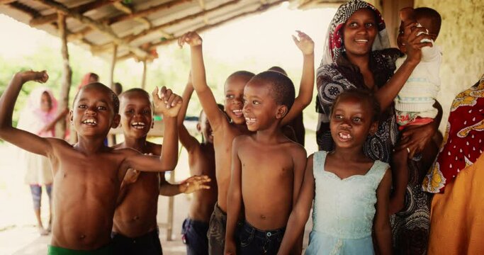 A Group Of African Children, Laughing, Jumping And Playing in Rural Area. Black Kids Celebrating Life with Joy. Camera Captures Beauty and Essence Of Childhood, Innocence and Purity of Live in Village