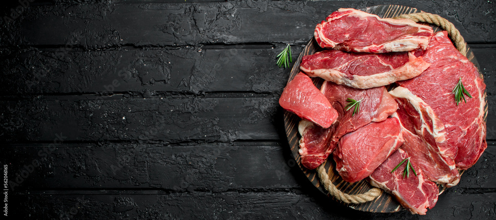 Canvas Prints raw meat. beef and pork steaks on a wooden tray.