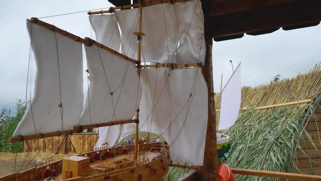 A sailboat model flutters in the wind.