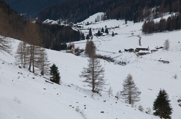 Panoramic view of little mountain village with snow in winter season, Alto Adige, Italy