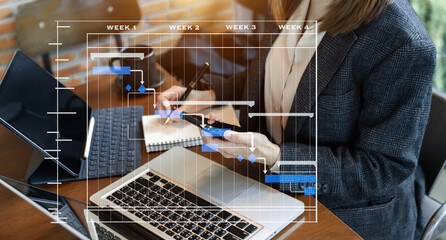 Project manager working and update tasks with milestones progress planning and Gantt chart scheduling diagram. business working with smart phone, tablet and laptop in office...