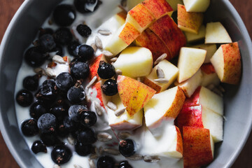 Healthy fruit and yogurt breakfast bowl on a wooden surface