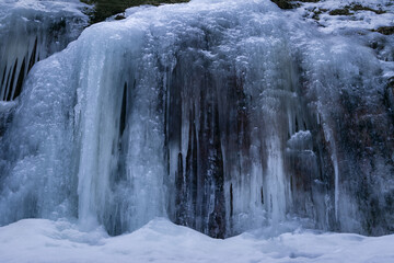 Clear blue ice wall on top of a rock