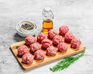Raw beef meatballs with spices and fragrant dill .