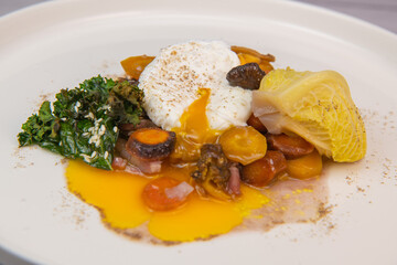 Recipe for braised cabbage, multicoloured carrots, onions, chanterelle mushrooms, poached egg and kale chips Hight quality photo