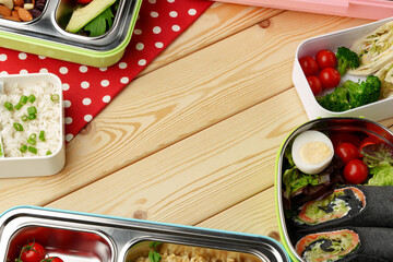 Containers with healthy food on wooden background top view.