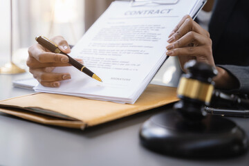 Close up businessman or Lawyer signing contract making a deal, classic business at office in the...