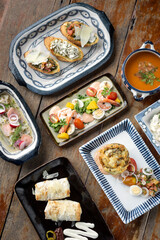selection of many different tapas on rustic wood table