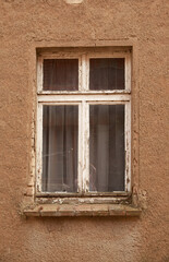 Fototapeta na wymiar Windows in old houses, wooden. frames and shutters on the windows in the village. 