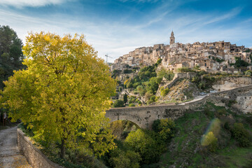 Fototapeta na wymiar Panoramic image view to Bocairent village against rocky mountains and clear blue sky background. Comarca of Vall d`Albaida in Valencian Community, Spain