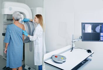 Mammography procedure, breast cancer prevention.Mature woman getting breast screening or mammography scan at medical clinic with mammologist