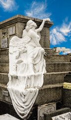 Angel statue among the Mausoleums and Crypts at the cemetery slums at the North Cemetery in Manila, Philippines