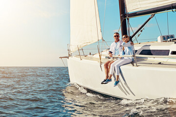 Yacht, travel or love and a mature couple sitting on a boat out at sea with blue sky mockup and...