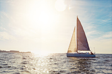 Mockup, sunset and a yacht at sea for travel, tourism or a luxury summer vacation outdoor. Blue sky, water and wave with a boat on the ocean in nature for an adventure, holiday or getaway with flare