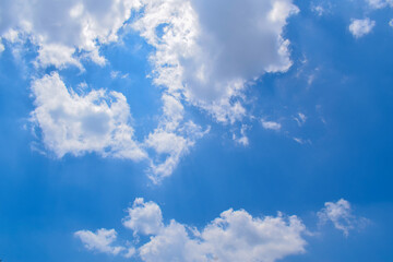 Deep blue skies with white clouds background, blue cloudy skies texture, dark blue sky wallpaper with with white fully clouds and sunlight.