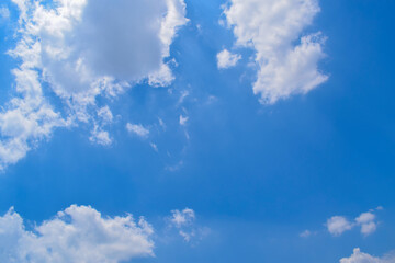 Naklejka na ściany i meble Deep blue skies with white clouds background, blue cloudy skies texture, dark blue sky wallpaper with with white fully clouds and sunlight.