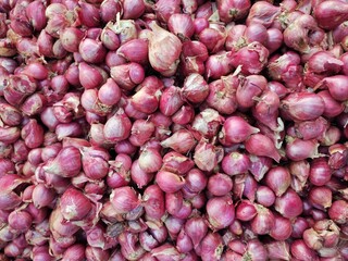 pile of red onions in the market. fresh onion background