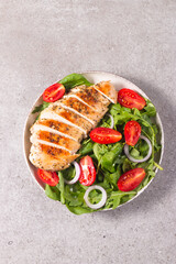 Salad with grilled chicken fillet meat, fresh vegetables, spinach, ruccola, red onion and tomato. Healthy menu. Diet food. Top view. Banner 