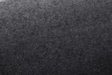 The texture of cardboard painted in black, flat background