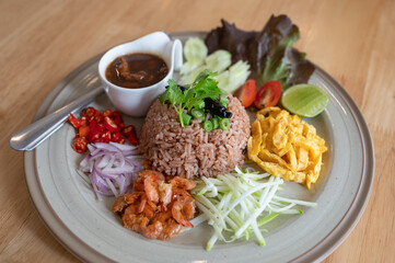 Fried rice mixed with shrimp paste with marinated pork, herb and vegetable is Thai traditional food