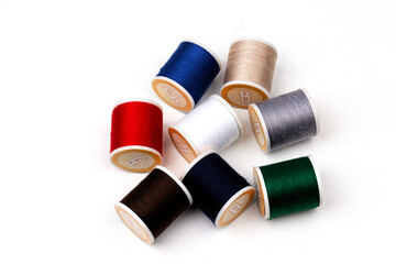 group of sewing spools isolated on white background with real shadows, different colors