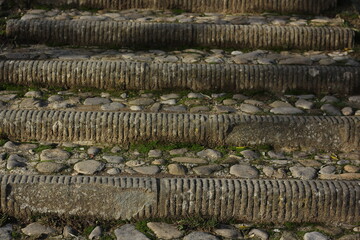 medieval staircase consisting of different stones and pieces of marble leading up