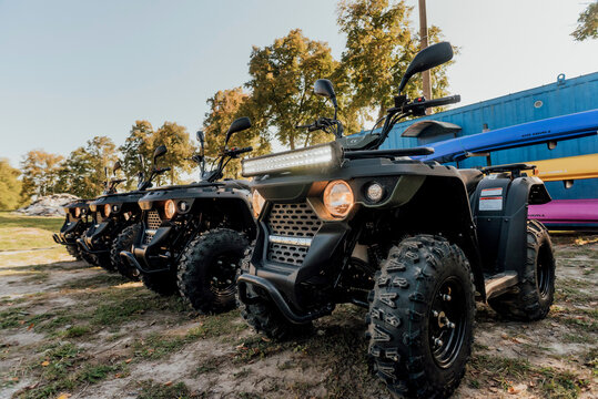 "Berdychiv,Ukraine - 9 September 2021. Pretty girls having fun
 and ride quad bikes on a dirt road "