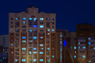 Residential buildings in the city in evening at night in winter