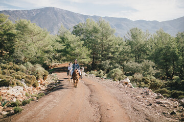 Obraz premium Group of people walking on horseback through picturesque places.