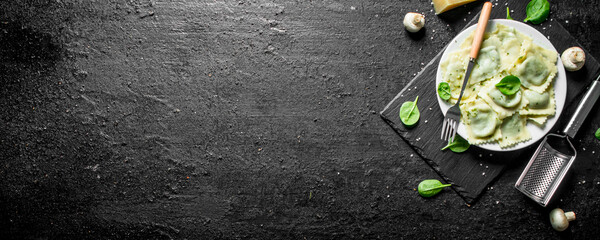 Italian ravioli with mushrooms and spinach leaves.