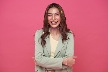 Happy cheerful young woman laugh looking at camera with joyful and charming smile isolated on pink studio background.