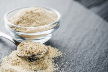 asafoetida aromatic powder on a black stone background