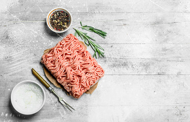 Raw minced beef with spices and herbs .