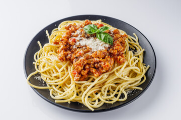 delicious Bolognese pasta on a black plate
