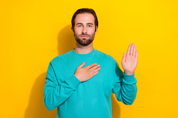 Photo of honest oath brunet hair young serious man touch chest palm showing trust respect confident person isolated on yellow color background - obrazy, fototapety, plakaty