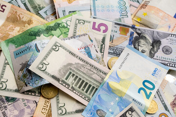 Background from different banknotes of dollars, euros, rubles, Belarusian rubles and other currency.