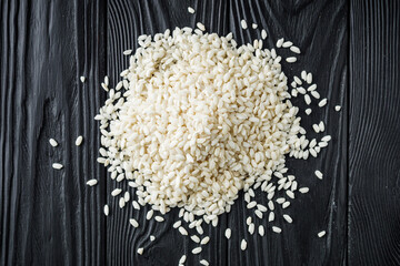 arborio rice for risotto on a black wooden background