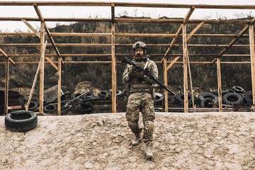 Soldier in camouflage with a rifle in hands