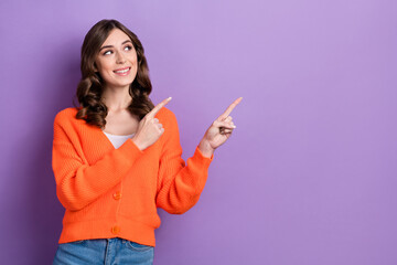 Portrait of cheerful gorgeous person look indicate fingers empty space isolated on purple color background