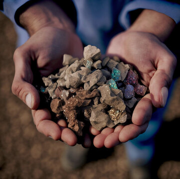 Male hands holding rare earth mineral. Mining concept.