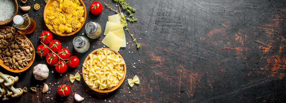 Different types of raw paste with thyme, tomatoes and mushrooms.