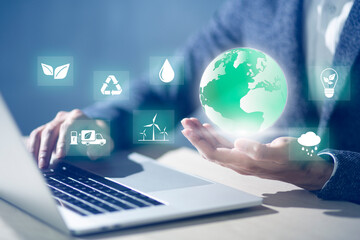 Businessman holding world with economy system icon digital sustainability and Sustainable Technology concept