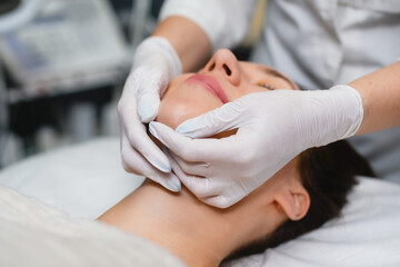 Face beauty massage in salon close up