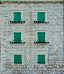 Fototapeta na wymiar Old stone building with shutters