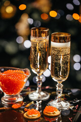 glass of champagne with red caviar appetizer cracker, butter and red caviar. Festive drink. Valentins or Christmas concept