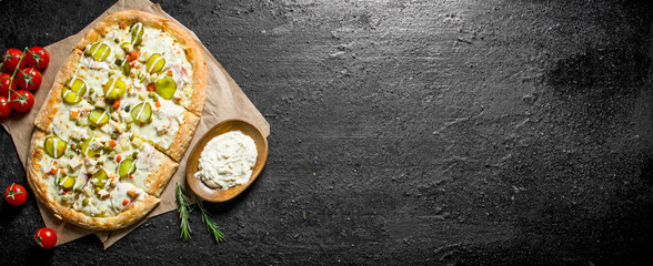 Vegetable pizza with cherry tomatoes and cheese sauce in bowl.