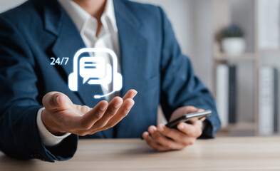Businessman with chat bot icon on virtual interface. 24/7 Chatbot service or artificial...