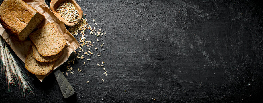 Fresh baked bread with spikelets and grains.